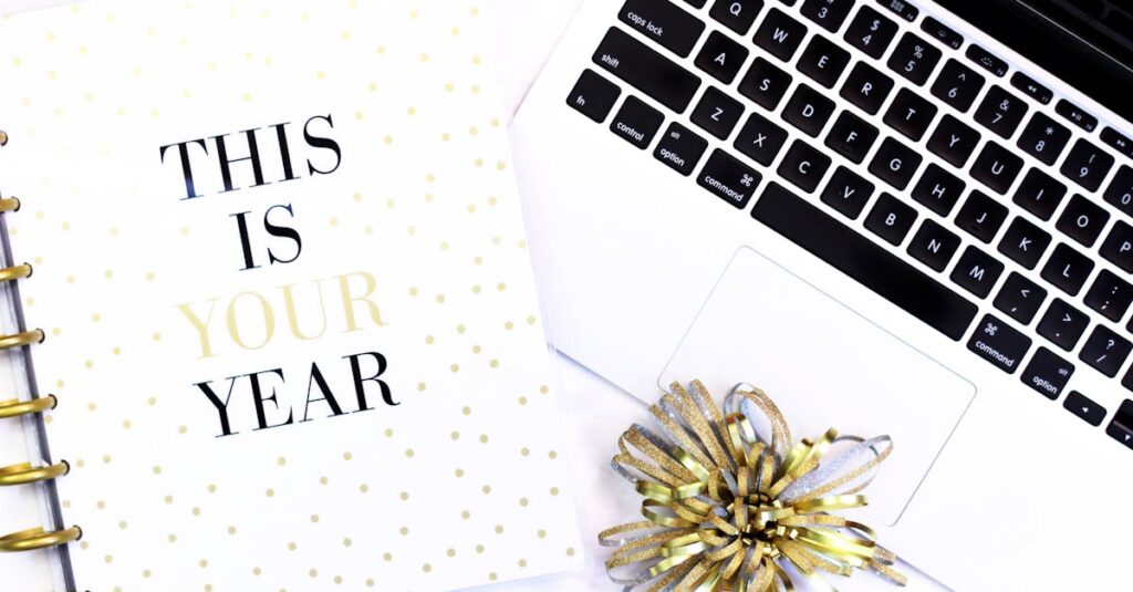 A stylish desk setup featuring a laptop and a motivational notebook for productivity inspiration.